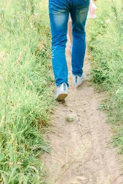 Man walking in a jeans - back view of legs Stock Photos