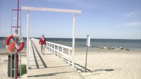 A man walking on a jetty Stock Footage 11287048