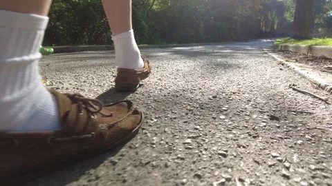 Man Walking As Jogger Passes On Left Side In Green Shoes And Bright Red Top Stock Footage 251879560