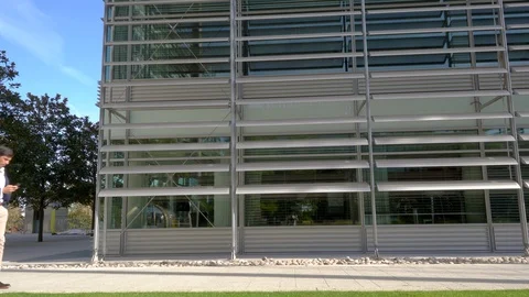 Man walking left to right using phone texting 4K Stock Footage 96051593