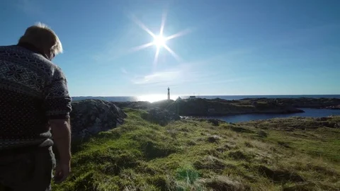 Man walking. With light house. Stock Footage 77974970