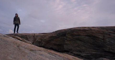 Man walking on limestone cliff. Stock Footage 106120270