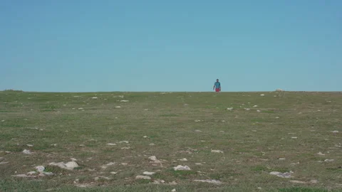 Man walking on lonely hill Stock Footage 287155994