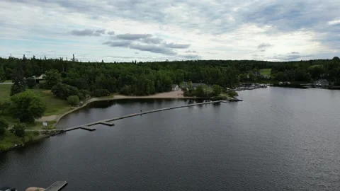 Man walking on a long bridge over the lake river 動画素材 320908246