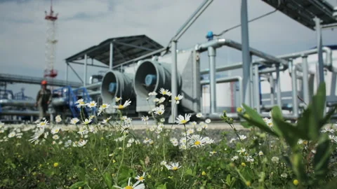 Man walking on modern facility with pump or powerful process area at oil depot o Video stock 199487763
