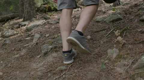 Man walking up mountain side Stock Footage 54708780