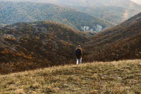Man walking in mountains Stock Photos