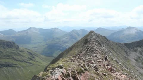 Man Walking on Mountainside HD File Stock Footage 10680046