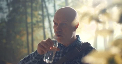 Man walking in nature and drinking water Stock Footage 151159314