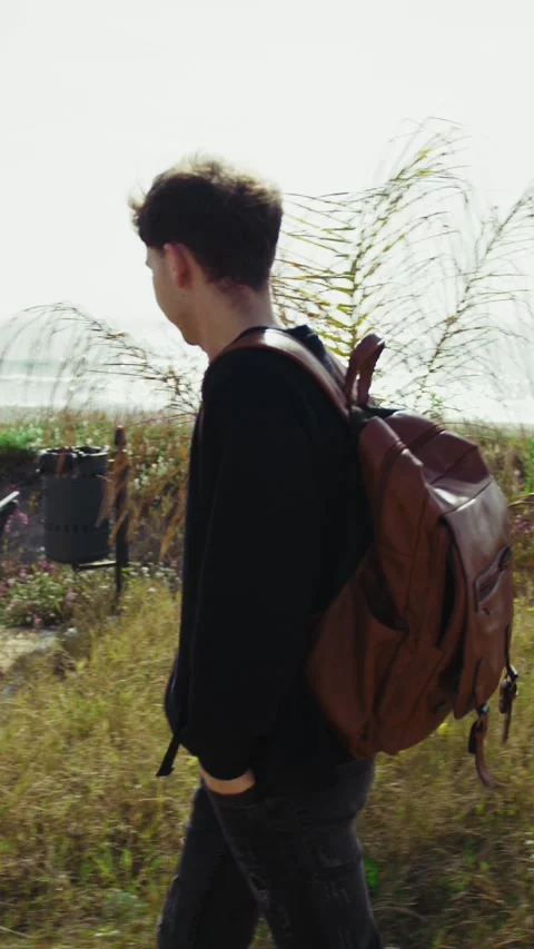 Man Walking Near The Sea With A Backpack After Work Stock Footage 315947341