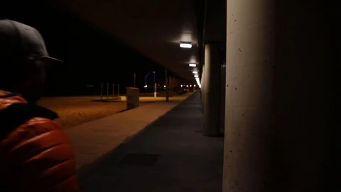 Man walking at night in the city Stock Footage 104123445