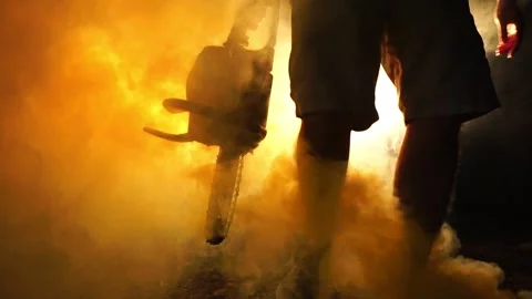 Man walking at night holding a weapon Stock Footage 228447775