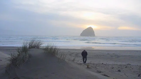Man Walking From Ocean Sunset Stock Footage 2579666