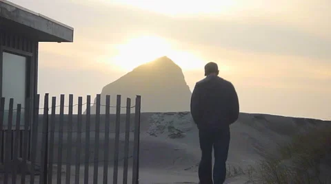 Man Walking From Oceanfront House To Sandy Beach Stock Footage 2578680