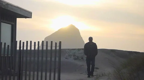 Man Walking From Oceanfront House To Sandy Beach 2 Stock Footage 2578837
