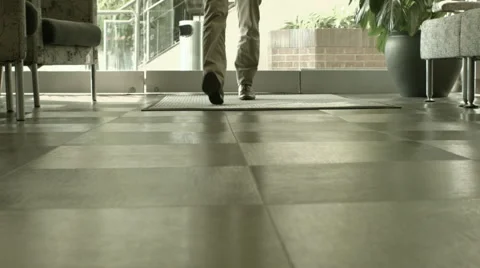 Man Walking into Office Lobby 库存影片 61236324