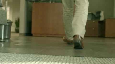 Man Walking into Office Lobby Stock Footage 61236554