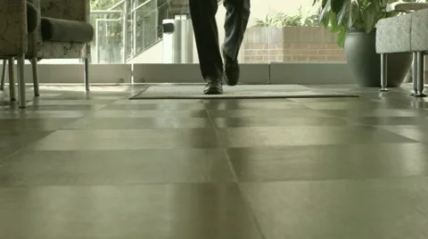 Man Walking into Office Lobby Stock Footage 61236632