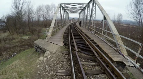 Man walking on an old railway bridge Stock Footage 45638997