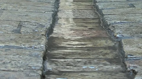 A  man walking in an old rain drain in a street in the old city of jerosulem Vidéo 55640554