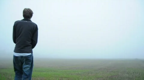 Man Walking Out Into A Big Empty Field Stock Footage 733723
