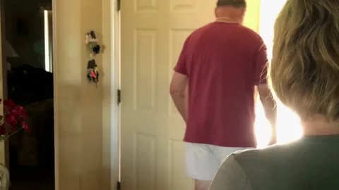 Man walking out front door leaving his wife Stock Footage 169680114