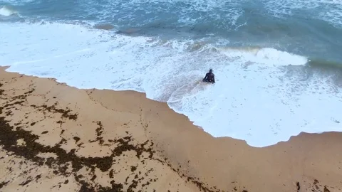 Man walking out of the waves Stock Footage 81203900