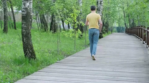 A man walking outdoors and throwing an empty plastic cup to grass, pollution Stock Footage 155208856