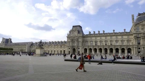 Man walking outside Le Louvre building and pyramid - panning - tracking - Paris Stock Footage 94062075