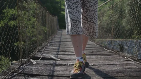 Man walking over the hanging bridge Stock Footage 89866712