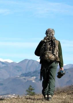 Man walking over the mountains Stock Photos