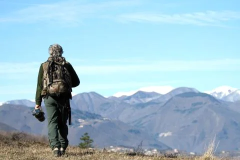 Man walking over the mountains Stock Photos