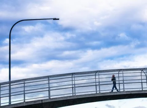 Man walking on overpass Stock Photos