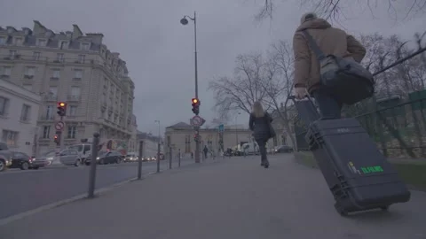 MAN WALKING IN PARIS WITH CASE Stock Footage 147663817