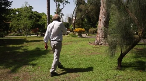 Man walking in the park Stock Footage 53003729