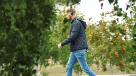 The man is walking in the park Stock Footage 84459027