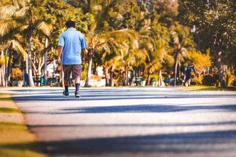 A man walking in the park. Stock Photos