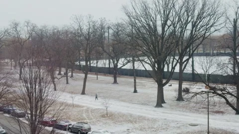 A man walking in the park while snow. Stock Footage 300659987
