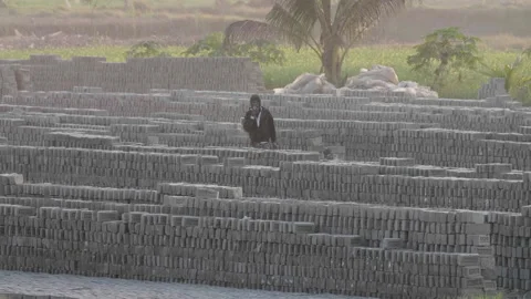Man Walking Past Bricks at Burning Chimney in Bangladesh Video stock 142039991