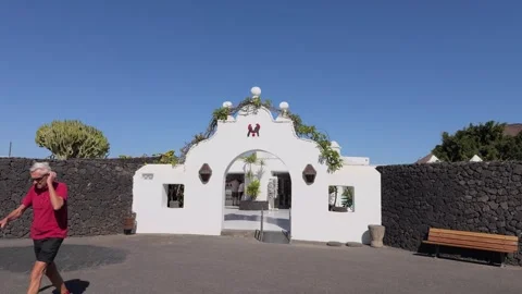 Man walking past Cesar Manrique House Museum architecture Stock Footage 337799880