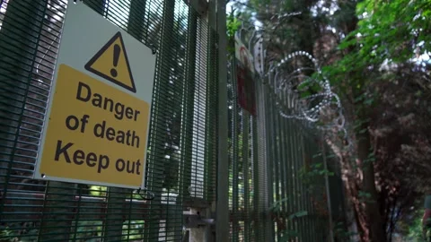A man walking past a danger of death sign Stock Footage 236404058