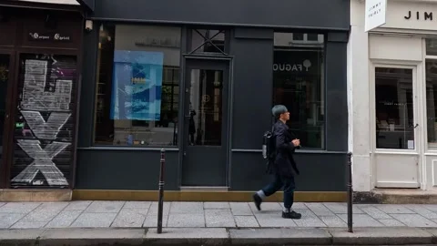 Man Walking Past Storefronts Stock Footage 289585843