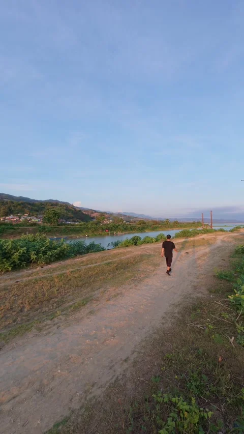 Man Walking on a Path by the Water Stock Footage 336735552