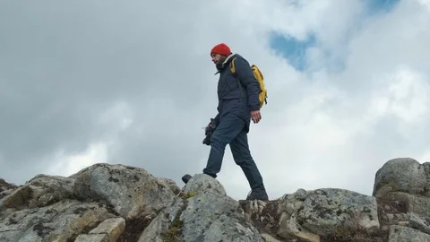 Man walking at the peak of a mountain at sunset in slow motion, Norway, Europe Stock Footage 109374439