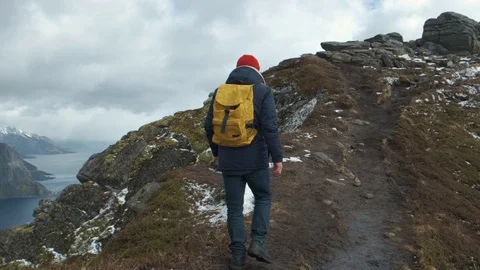 Man walking at the peak of a mountain at sunset in slow motion, Norway, Europe Stock Footage 109374659