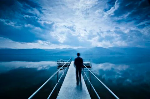 Man is Walking on the Pier Stock Photos