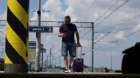Man walking on the platform and texting messages on smartphone Stock Footage 78651828