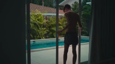 Man walking to private pool in Koh Phangan tropical villa Stock Footage 344314347