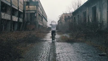 Man walking on a rail in abandoned building Stock Footage
