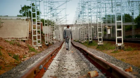 Man walking on railroad tracks Stock Footage 32578337
